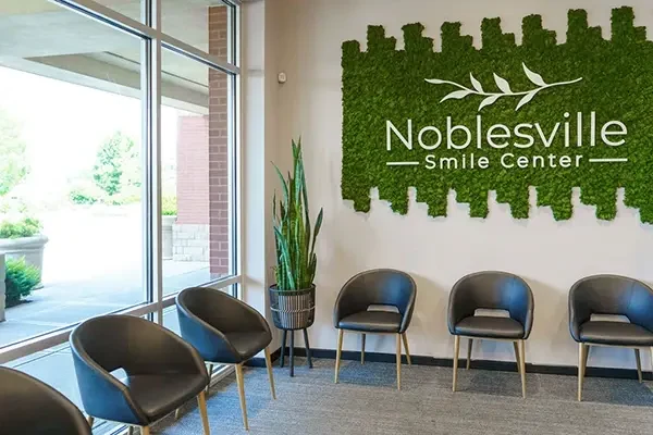 Noblesville Smile Center waiting area with the moss logo wall